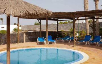 sun loungers in the swimming pool sbh royal mónica